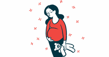 A pregnant woman stands holding a stuffed toy and cradling her belly.