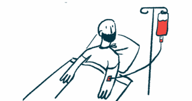 A patient wearing a face mask receives intravenous treatment in their arm while lying in a hospital bed.