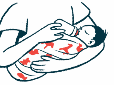 A baby cradled in a person's arms drinks from a bottle.