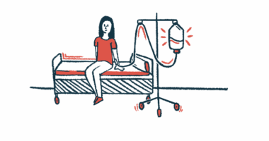 A woman is receiving an intravenous infusion while sitting on a bed.