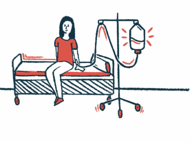 A woman is receiving an intravenous infusion while sitting on a bed.